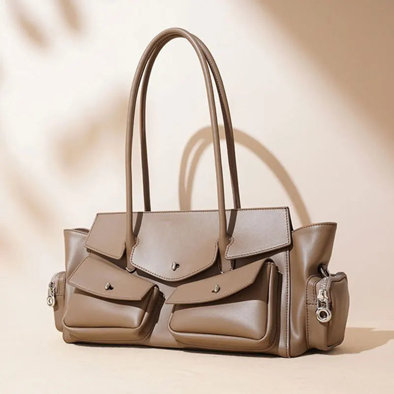 Beige handbag with multiple pockets and handles on a beige background