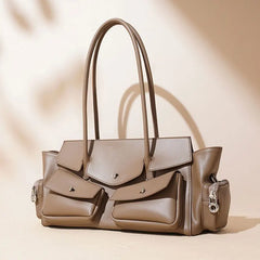 Beige handbag with multiple pockets and handles on a beige background