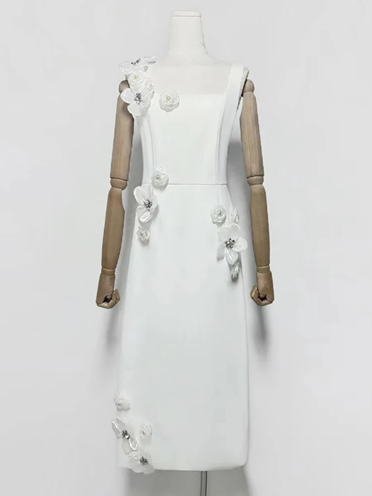 White dress with floral embellishments on a mannequin against a white background