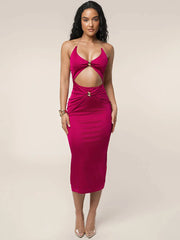 Woman wearing a pink dress with cut-out design on a beige background