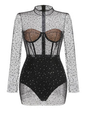 Black bodysuit with sheer long sleeves and rhinestone embellishments on a white background