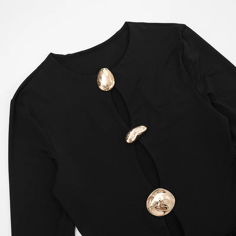 Black garment with gold buttons on a light gray background