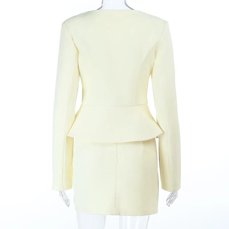 An apricot suit on a mannequin against a white background