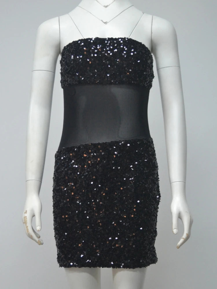 Black sequin dress on a mannequin against a gray background