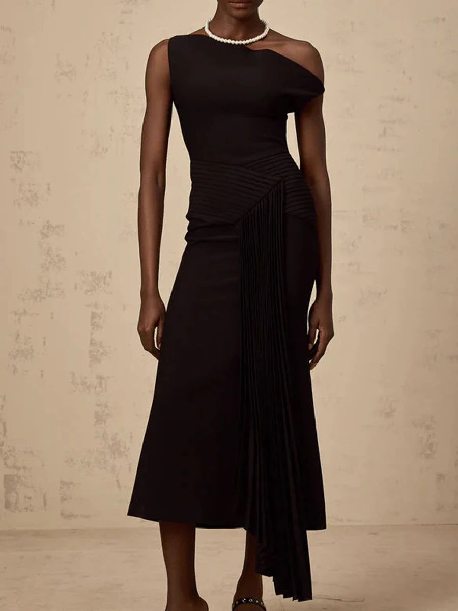 Black dress with sheer shoulder on a neutral background