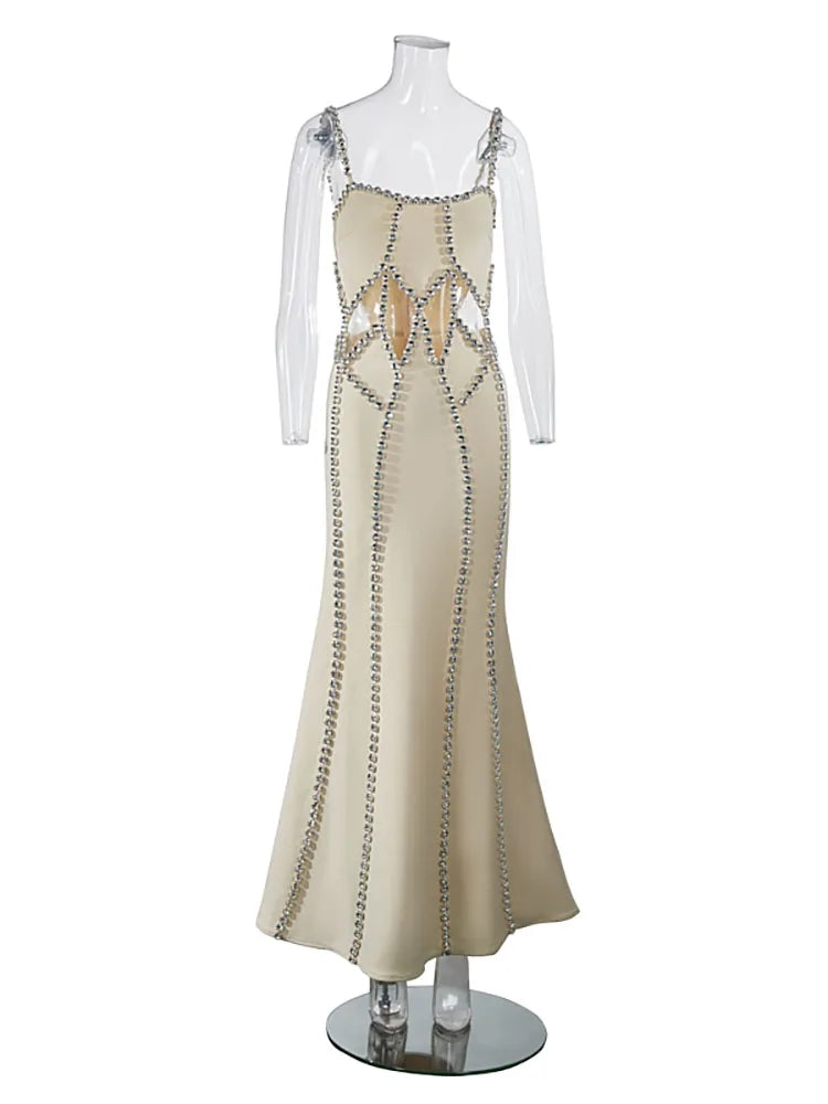 Beige evening gown with intricate detailing on a mannequin against a white background