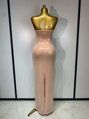 Back view of a strapless sequin column maxi dress with a slit
