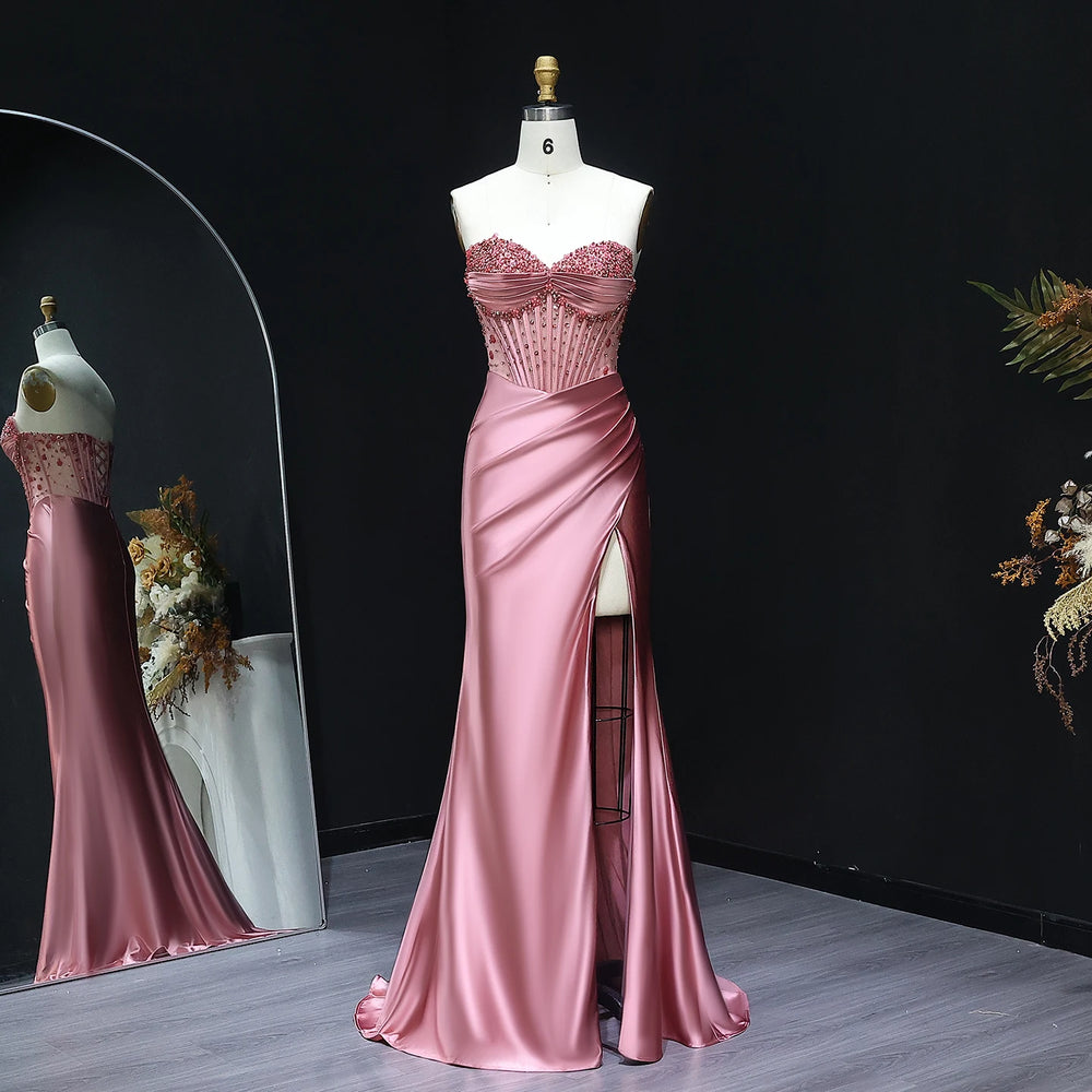 Pink evening gown on a mannequin against a dark background