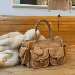 Caramel brown suede tote bag with shearling trim and multiple pockets