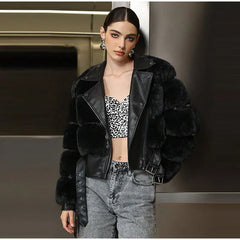 Woman wearing a black fur jacket over a leopard print top and gray pants.