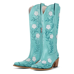 Turquoise cowboy boots with floral embroidery on a white background