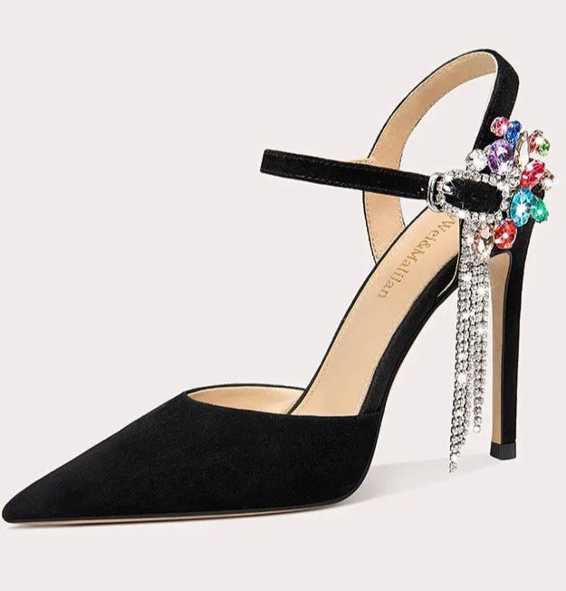 Black high-heeled shoe with colorful embellishments on a light gray background