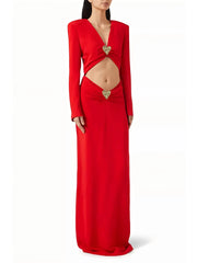 Red V neck cutout gown with metal heart accent styled for evening