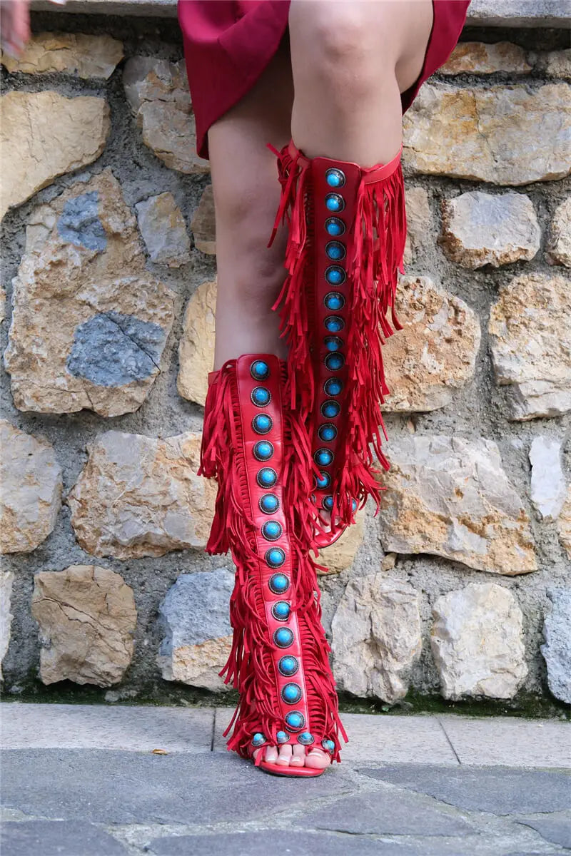 Model wearing fringed turquoise studded knee-high boots