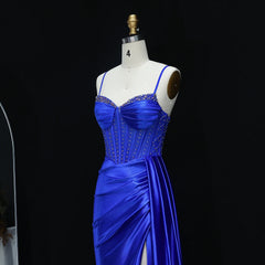 Blue evening gown on a mannequin against a black background