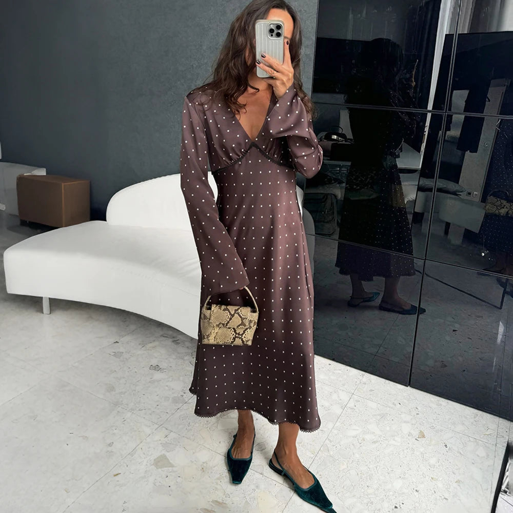 Model wearing brown polka dot v-neck dress