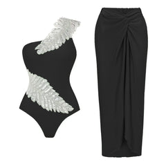 Black one-shoulder swimsuit with feather sequin embellishment and black draped maxi skirt