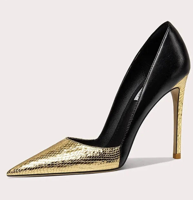 Black and gold high-heeled shoe on a light gray background