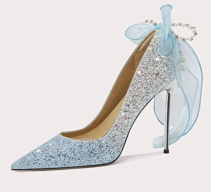 Sparkly high-heeled shoe with a decorative bow on a white background