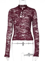 Maroon lace top on a mannequin against a white background