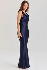 Navy blue evening gown on a model against a white background