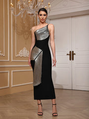 Woman wearing a black and silver one-shoulder dress in an elegant indoor setting.