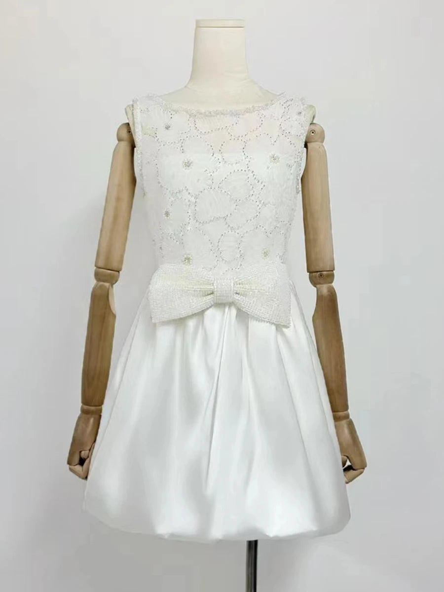 White lace dress on a wooden mannequin against a white background