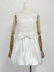 White lace dress on a wooden mannequin against a white background