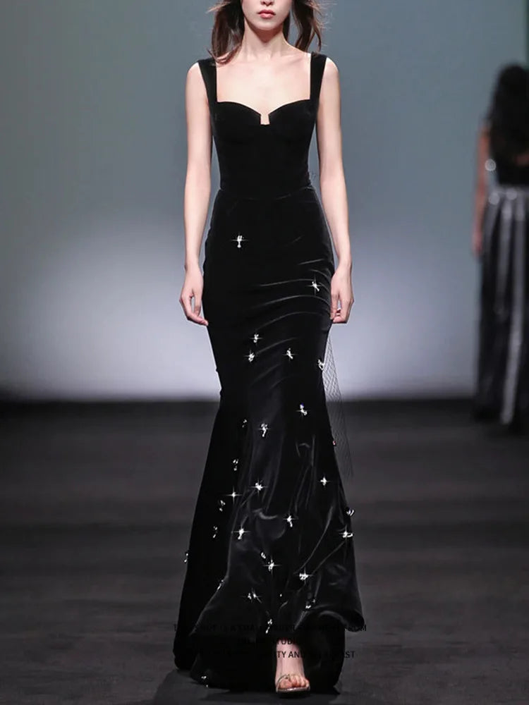 Black velvet mermaid maxi dress with spaghetti straps and beaded embellishments, front view.