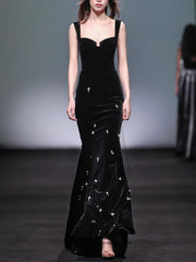 Black velvet mermaid maxi dress with spaghetti straps and beaded embellishments, front view.