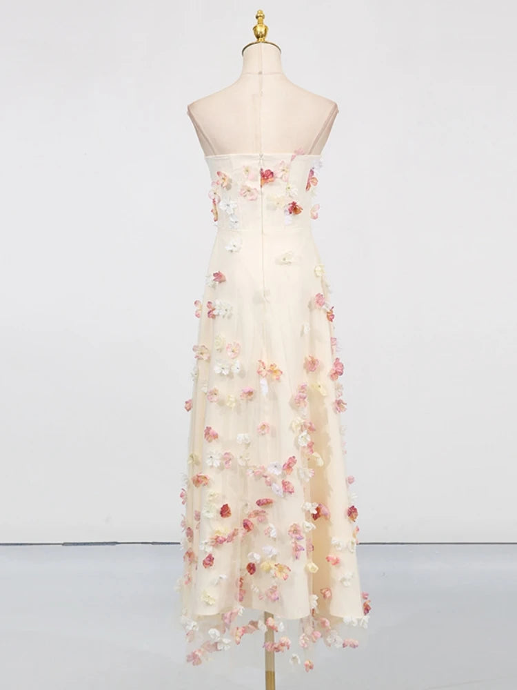 Elegant strapless dress with floral embellishments on a mannequin against a white background