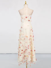Elegant strapless dress with floral embellishments on a mannequin against a white background