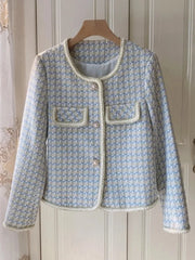 Light blue textured jacket with white trim on a wooden hanger against a neutral background