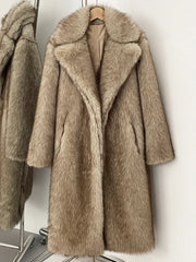Beige faux fur coat on a hanger against a white background