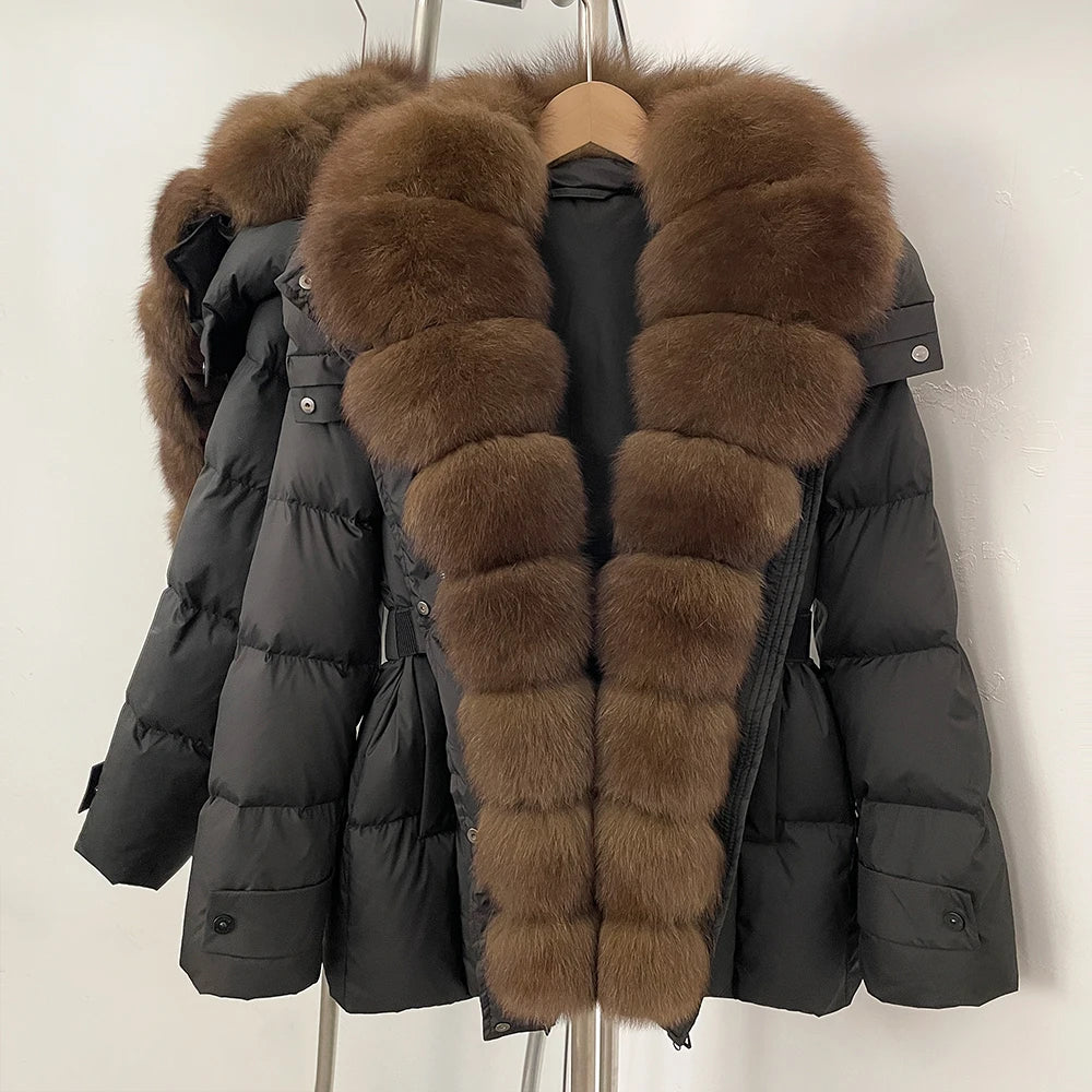 Black puffer jacket with brown fur trim on a hanger