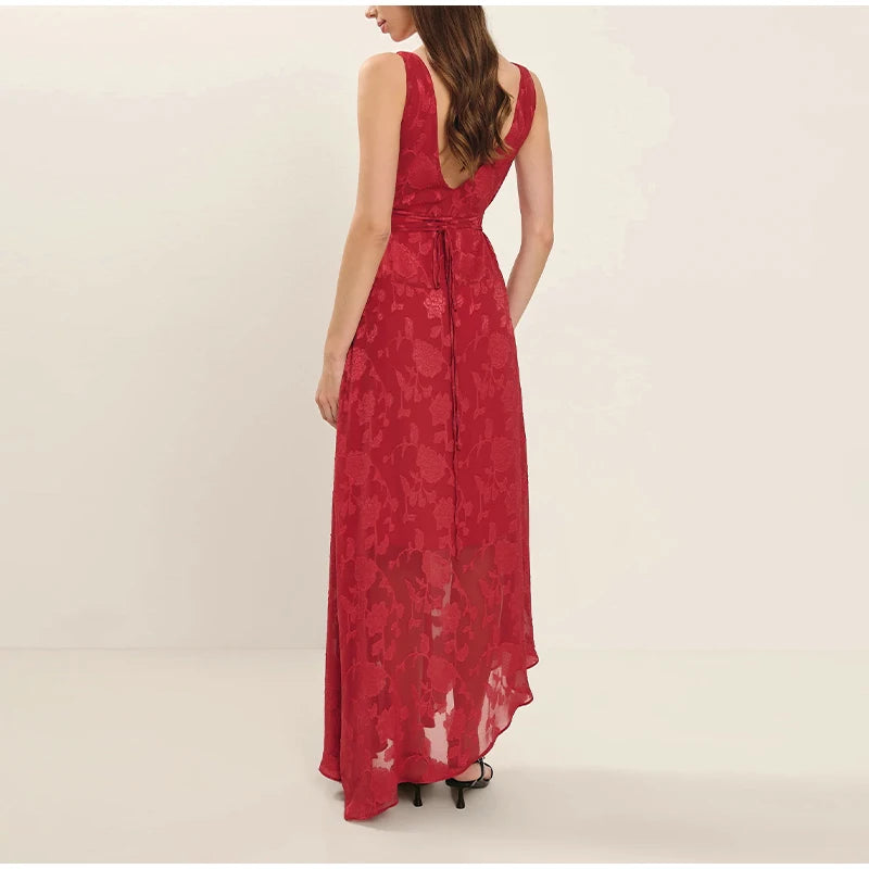 Red floral dress on a model against a plain background