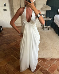 Woman wearing a white one-shoulder dress in an indoor setting.