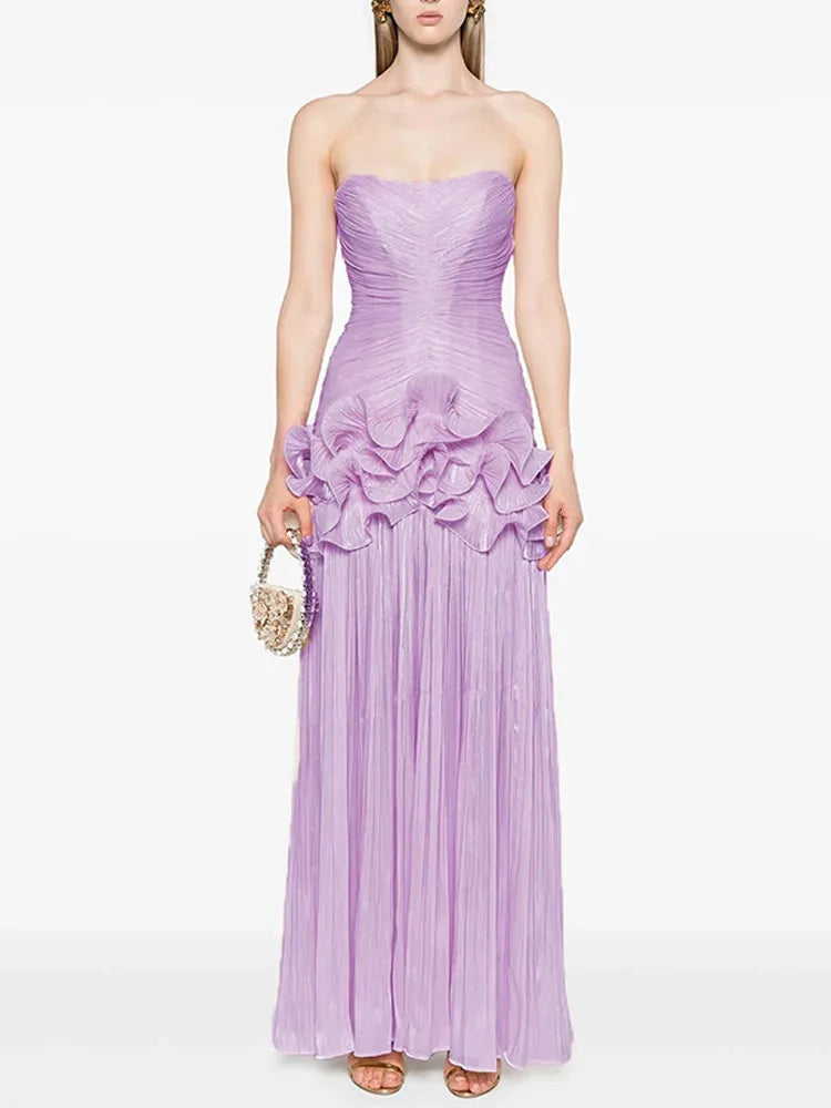 Woman wearing a strapless purple gown with ruffled details