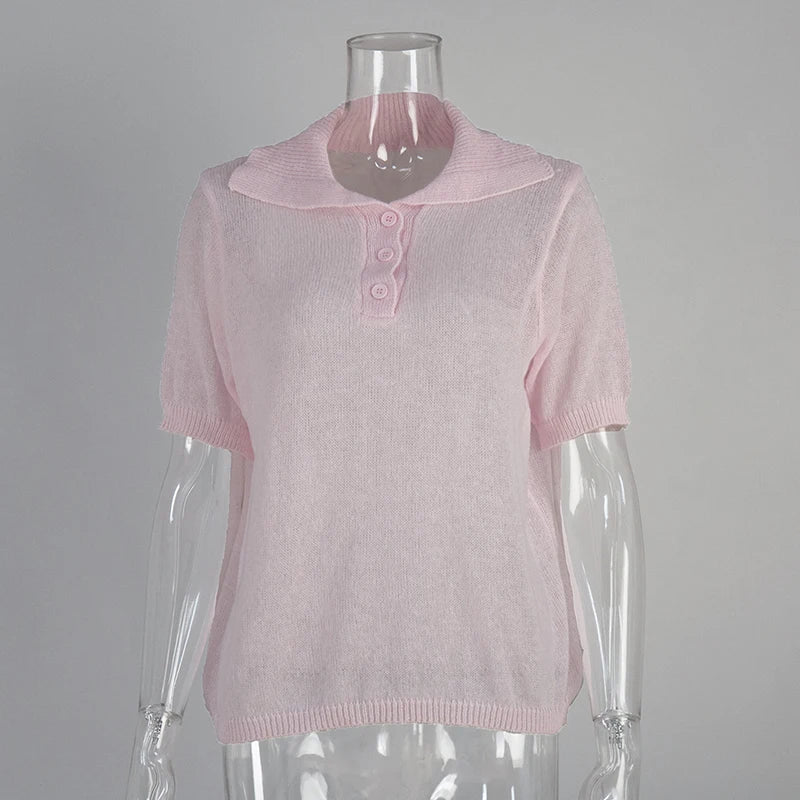Pink short-sleeve top on a mannequin against a grey background