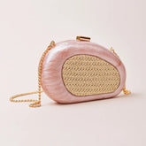 Pink sculptural resin clutch with woven inlay and gold chain strap