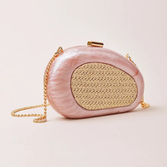 Pink sculptural resin clutch with woven inlay and gold chain strap