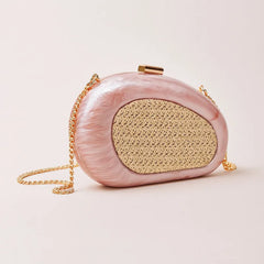 Pink sculptural resin clutch with woven inlay and gold chain strap