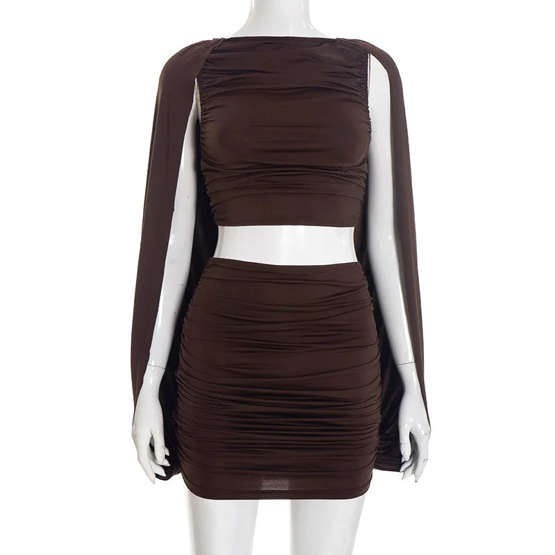Brown dress with cape on a mannequin against a white background