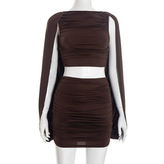 Brown dress with cape on a mannequin against a white background