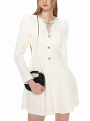 White dress with buttons and a black clutch held by a person