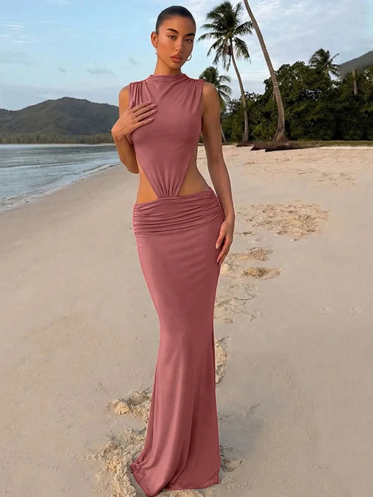 Sleeveless turtleneck cutout maxi dress on a beach