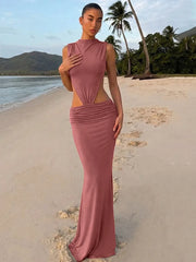 Sleeveless turtleneck cutout maxi dress on a beach