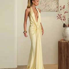 Woman wearing a yellow evening gown in an indoor setting.