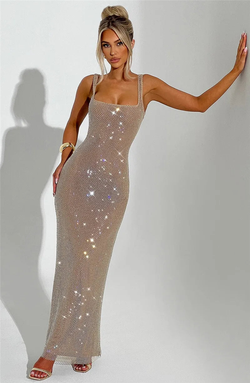 Woman wearing a sparkly beige dress against a plain background
