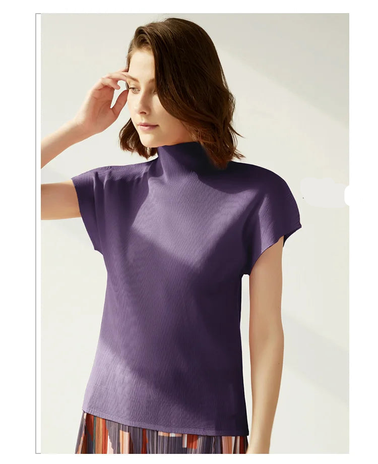 Woman wearing a purple top with a plain background